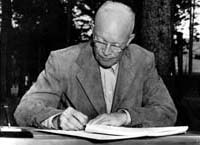 Photograph of President Eisenhower signing the 1954 Social Security Amendments initiating the disability 'freeze'